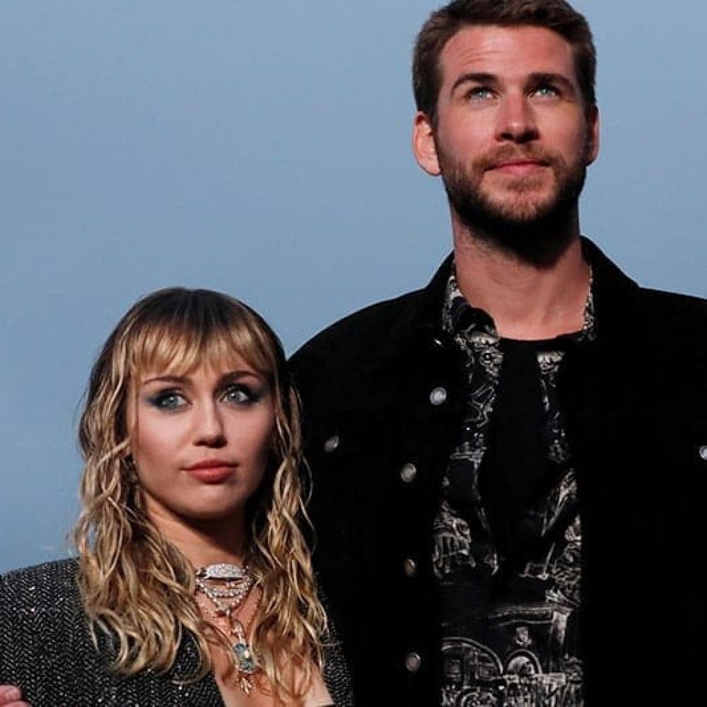 Miley Cyrus and Liam Hemsworth look on at the Saint Laurent Men’s Spring/Summer 2020 fashion show at Paradise Cove beach in Malibu