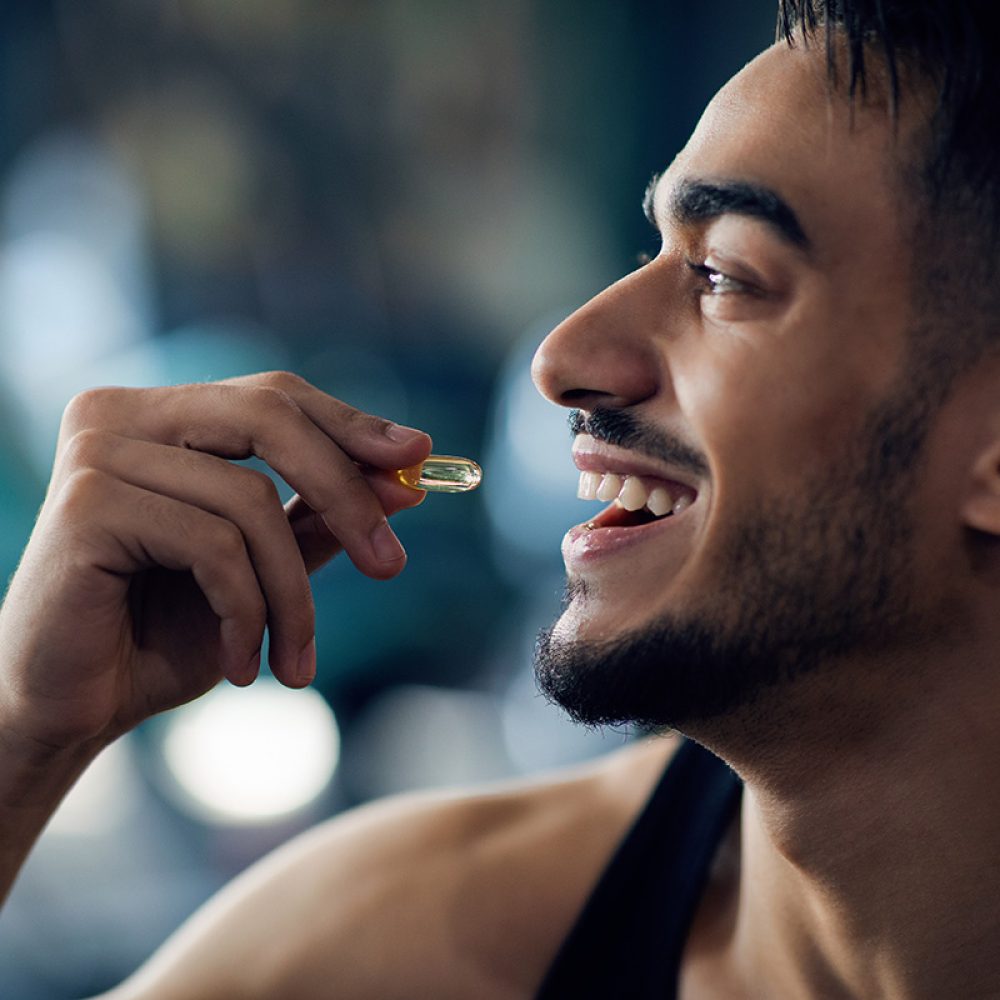 Portrait,Of,Happy,Sportive,Arab,Man,Taking,Supplement,Capsule,,Closeup